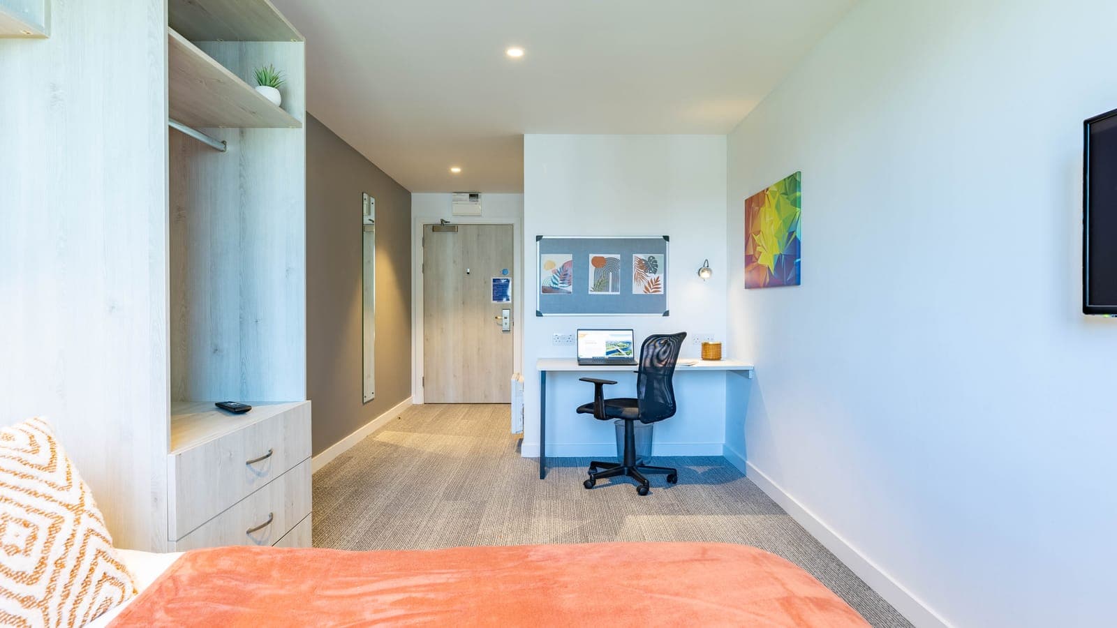 An en-suite room at ABeleven seen from the bed, with a study desk and chair at the window